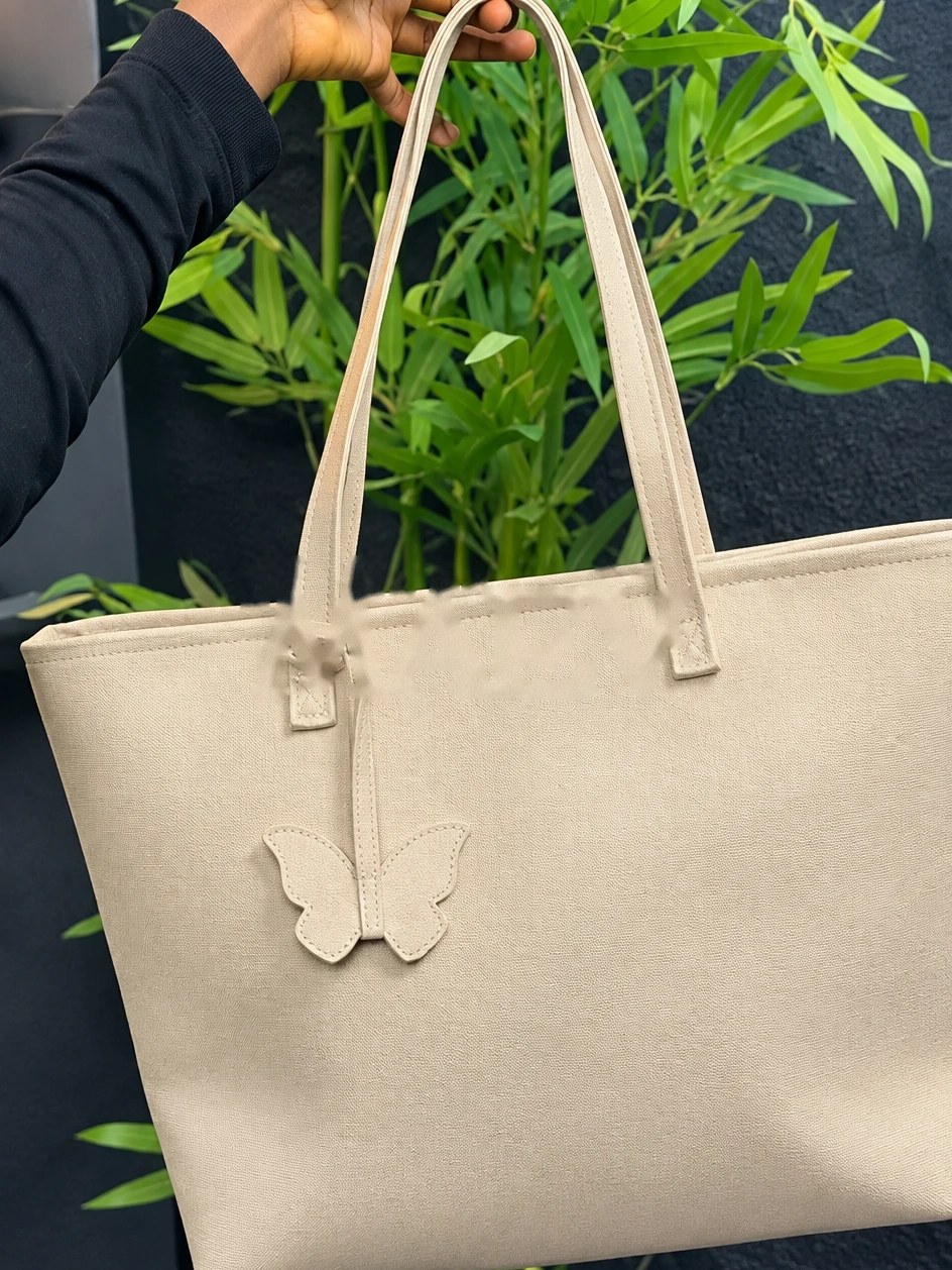 MAEV tote in Sand, a soft warm neutral with a butterfly charm